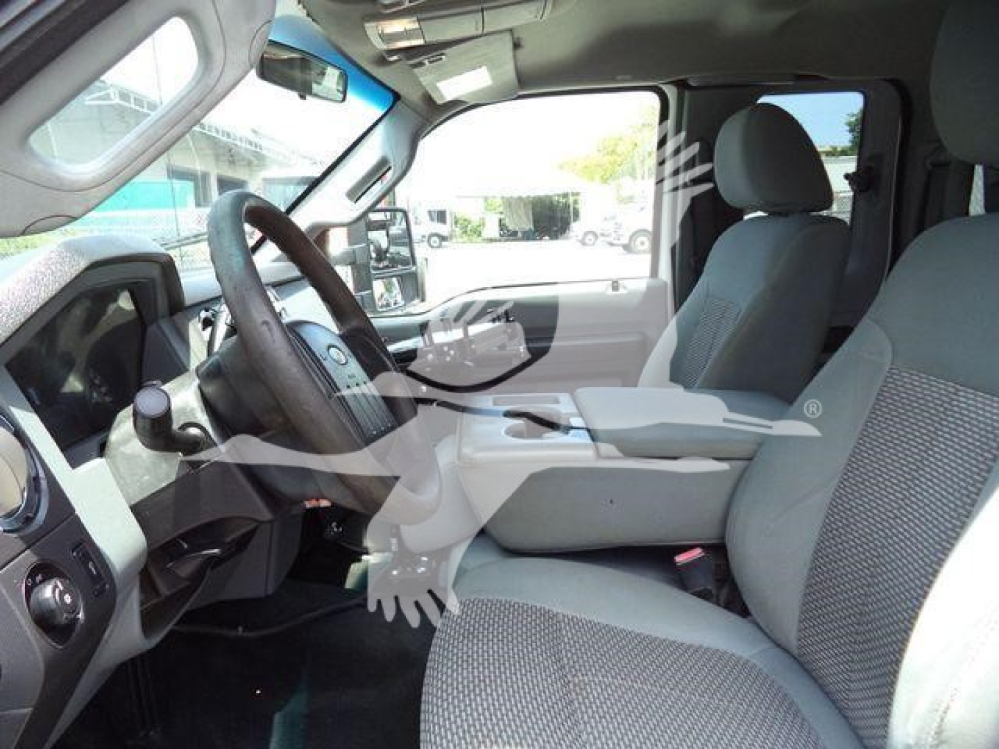 Ford F-450 XLT cab interior with driver seat and front passenger, dashboard, steering wheel.