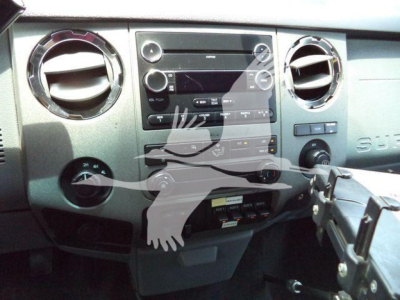 Ford F-450 dashboard and center console with radio, climate controls, and gear selector visible.