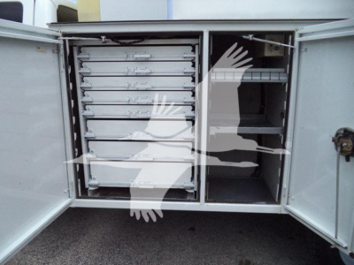 Ford F-450 utility truck with side compartments and multiple drawers in rear cargo area.