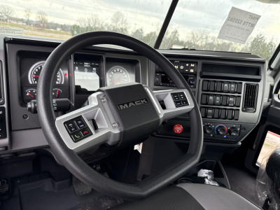 Mack PI64T dash and steering wheel in-cab view showing dashboard gauges and controls.