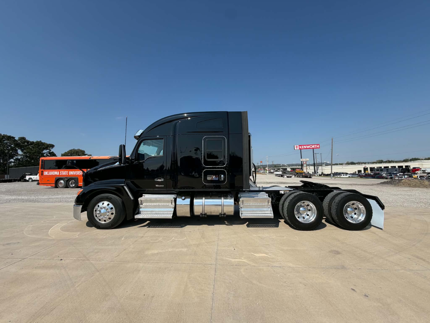 Kenworth T680 tractor from side view showing cab, fuel tanks, and dual rear axles.