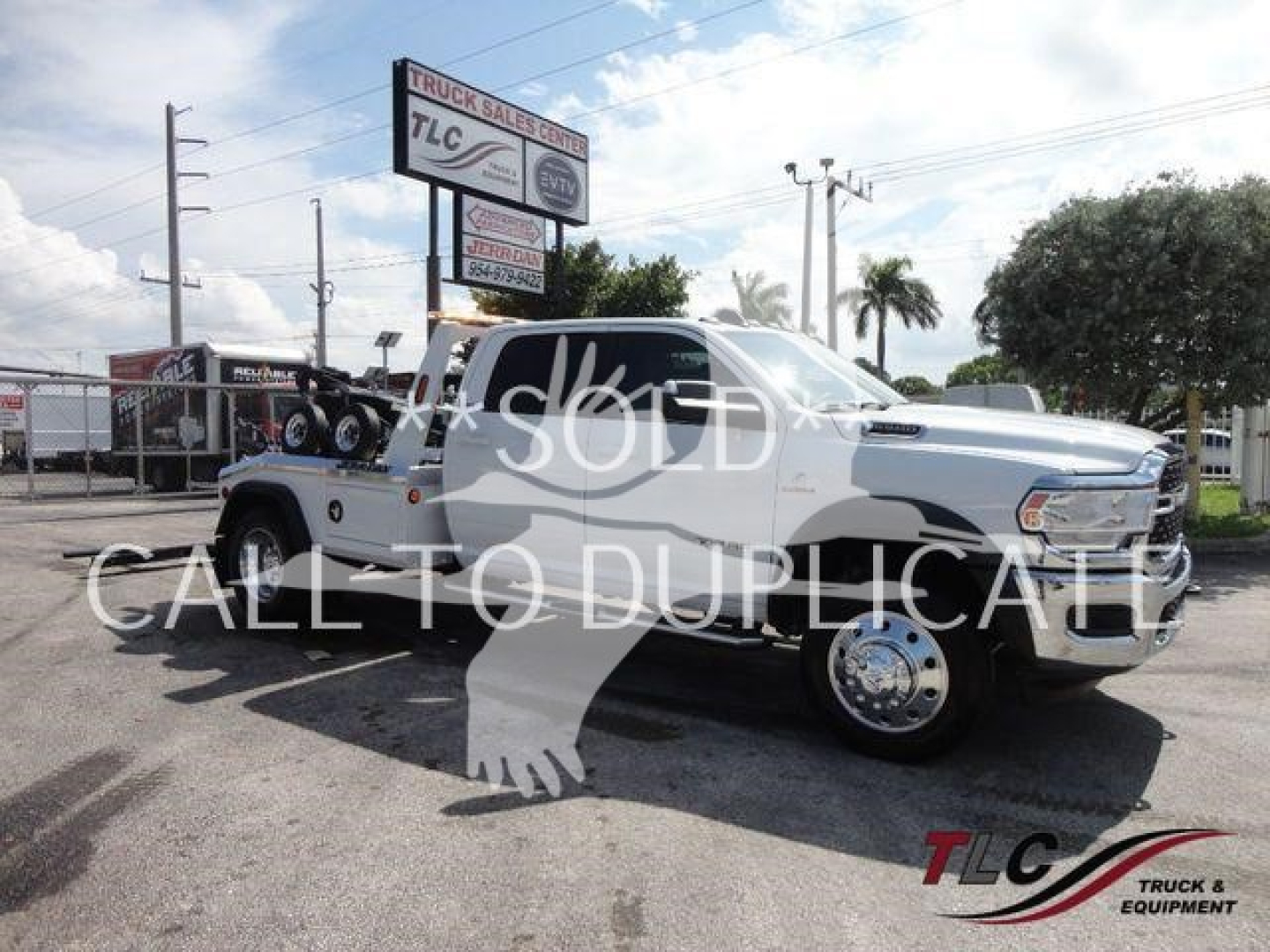 Ram 5500 SLT pickup truck in white with a utility flatbed, large dual rear wheels, and TLC Truck Sales Center signage in background; watermark text overlay says SOLD and CALL TO DUPLICATE.