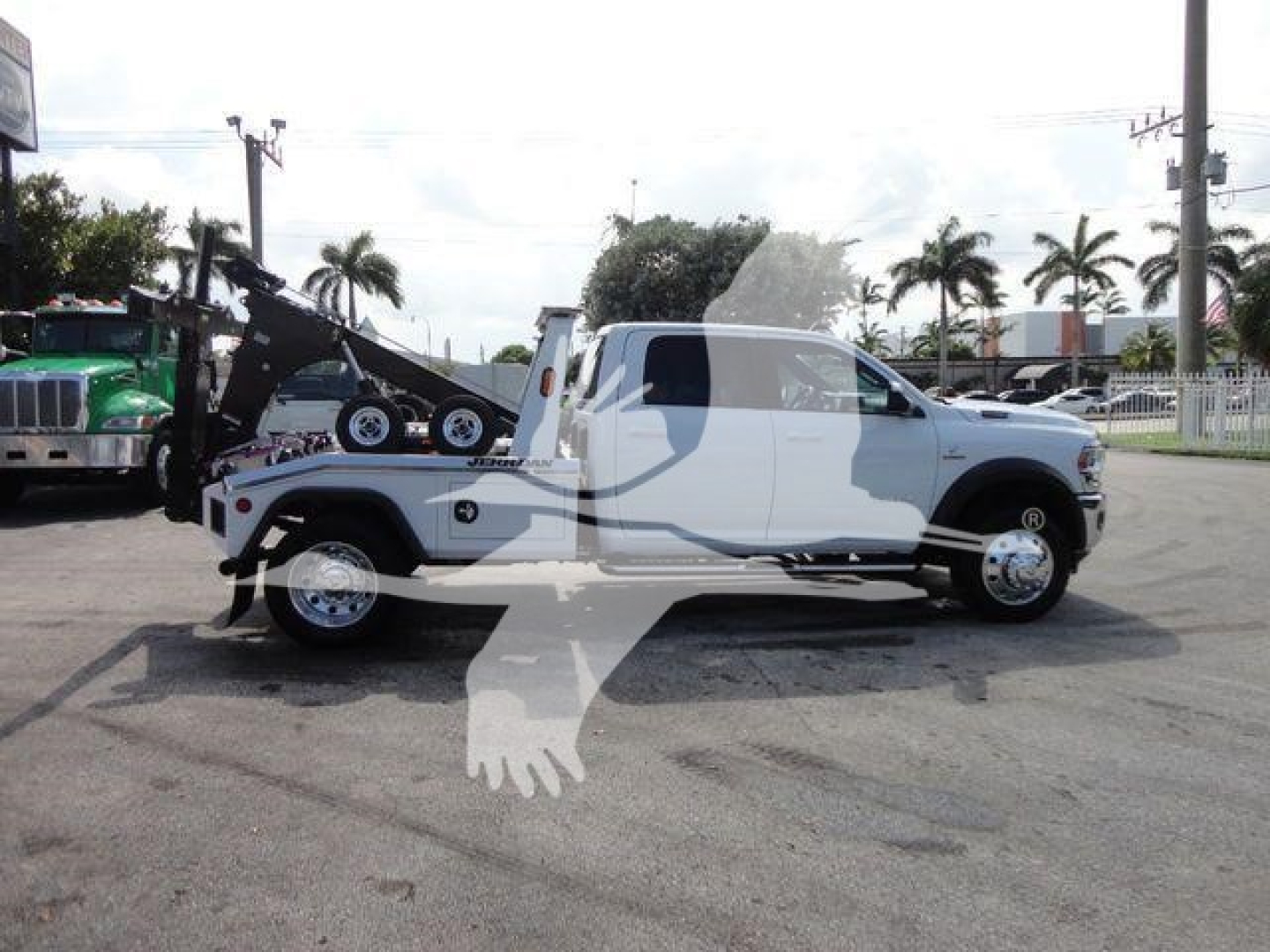 Ram 5500 SLT tow truck/flatbed with winch and tow setup, side profile view