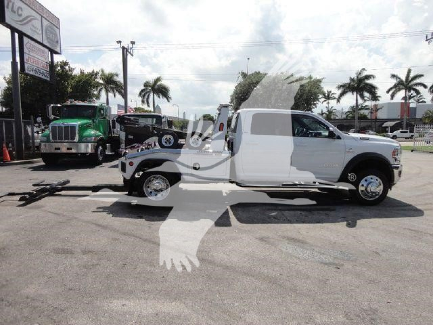 2024 Ram 5500 SLT truck with wrecked bed, side profile view in a dealership lot.