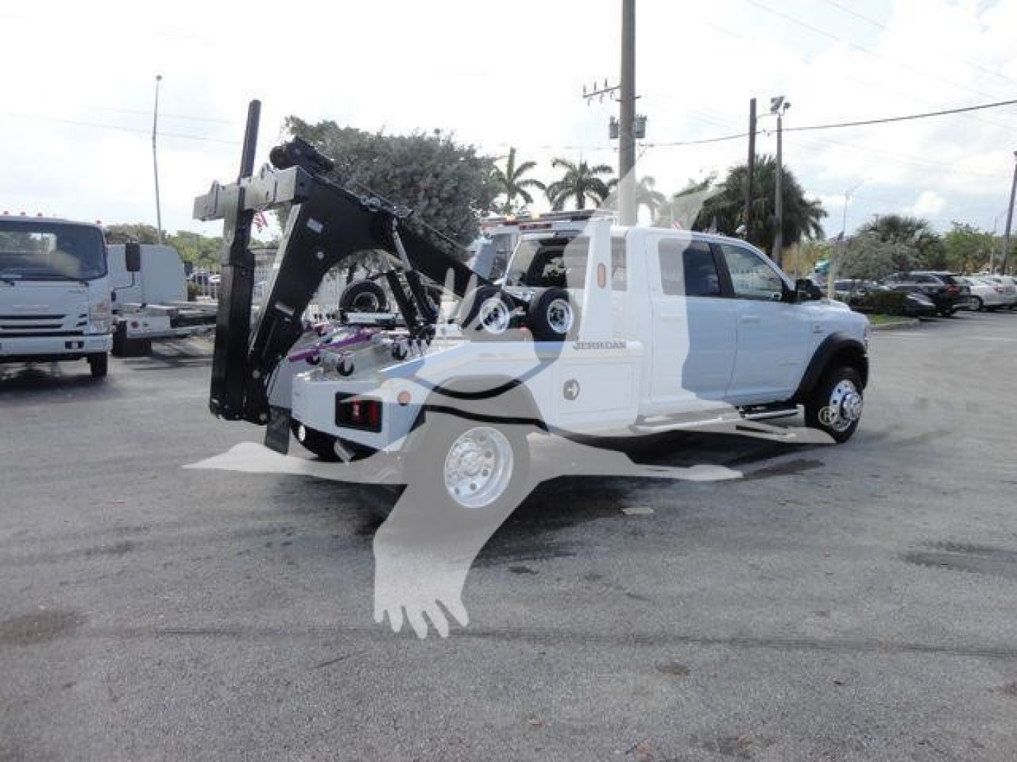 Ram 5500 SLT truck with heavy winch equipment mounted on rear, side view showing winch assembly and hitch