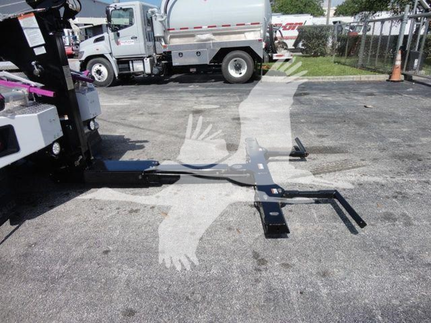 Ram 5500 SLT winch truck with a mounted front frame and winch assembly visible on a dealership lot.