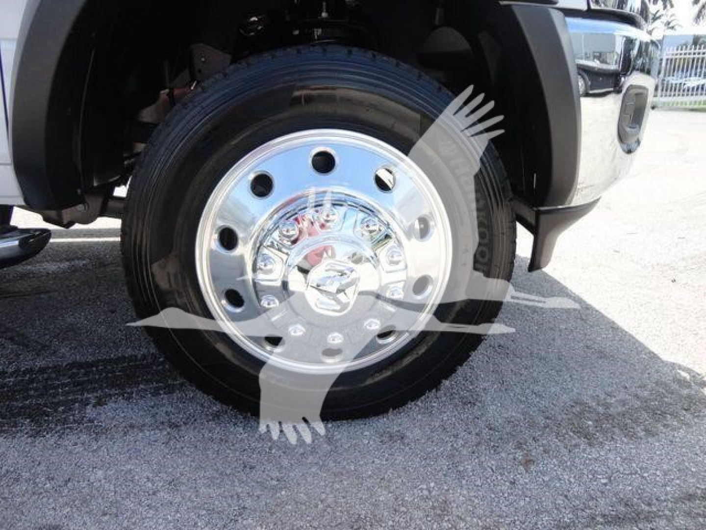 Ram 5500 wheel with chrome hubcap and tire visible in front of truck fender.