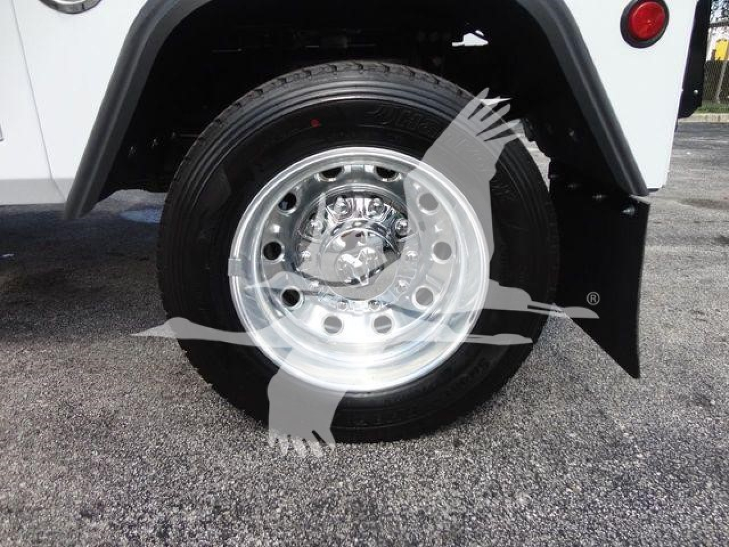 Wheel and tire close-up on a RAM 5500 truck showing polished wheel and tire with fender and mudflap.