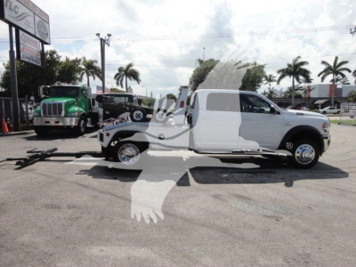 2024 Ram 5500 SLT truck with wrecked bed, side profile view in a dealership lot.