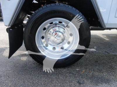 Wheel close-up of a Ram 5500 SLT truck showing a Hankook tire mounted on a polished metal wheel with dual-hole pattern and lug nuts.