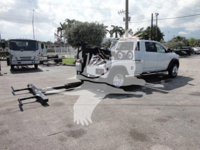 Ram 5500 SLT truck with winch attachment and tow setup in front of dealership.