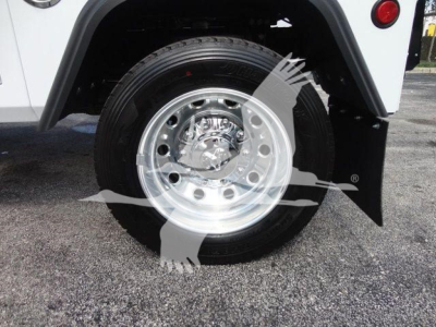 Wheel and tire close-up on a RAM 5500 truck showing polished wheel and tire with fender and mudflap.