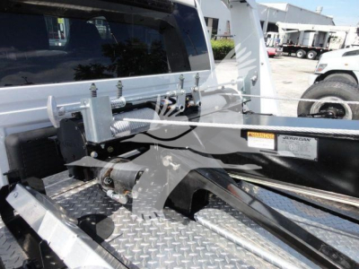 Winterized truck bed showing electrical winch and steel mounting hardware on diamond plate deck.
