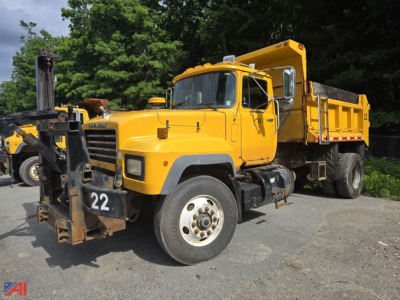 Yellow 2004 Mack RD690P dump truck in a parking lot showing front and side views with a front-mounted snowplow attachment labeled '22' and a dump bed in back.
