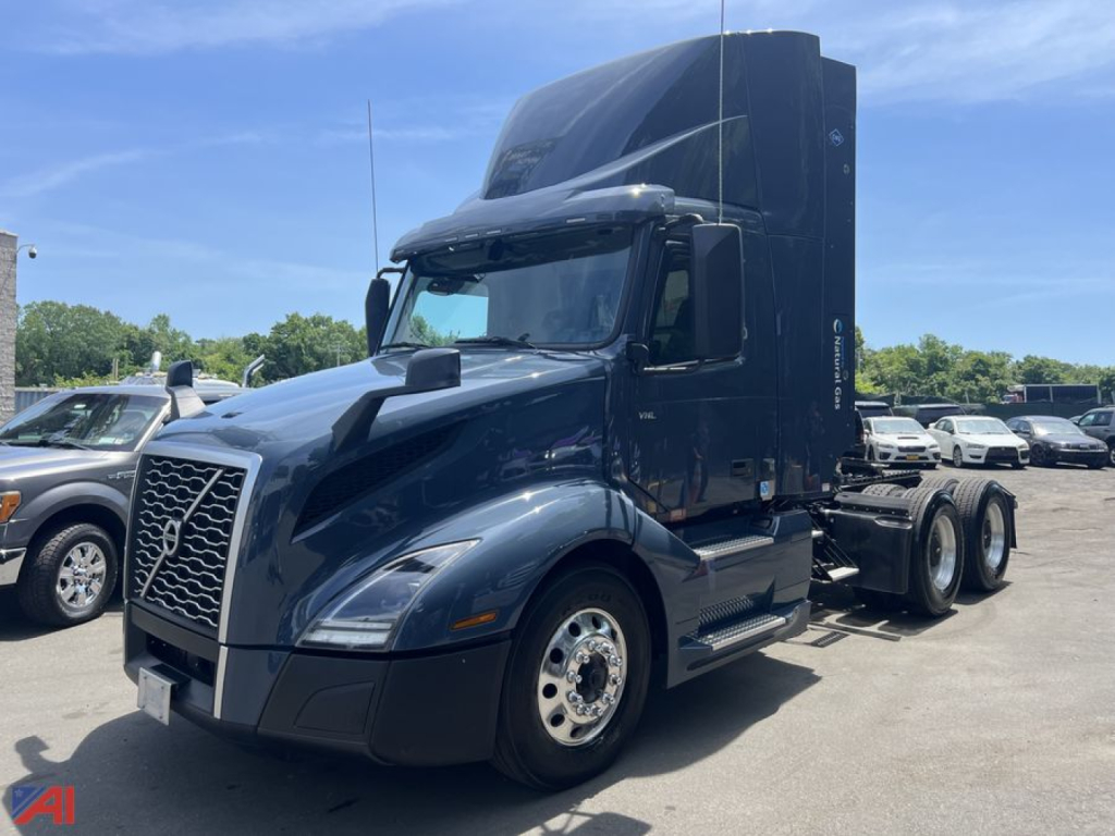 Volvo VNL day cab tractor in view showing front grille, cab, and attached sleeper with diesel truck chassis and six-wheel rear configuration.