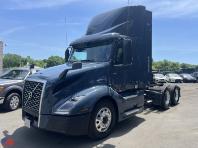 Volvo VNL day cab tractor in view showing front grille, cab, and attached sleeper with diesel truck chassis and six-wheel rear configuration.