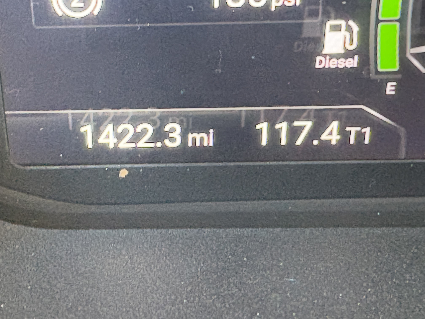 Dashboard display showing 1422.3 mi and 117.4T1 with diesel gauge and fuel icon on truck instrument cluster.