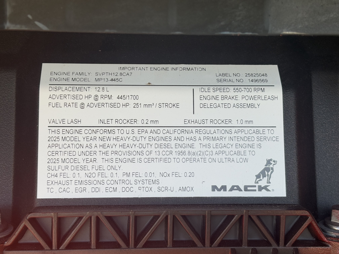 Engine information plate showing displacement 12.8 L, fuel rate, idle speed 550-700 RPM, engine family SPMT12B2 BCA7, MAK logo.