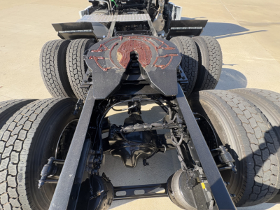 Mack PR64T chassis showing rear view with fifth wheel and dual rear axles and visible drivetrain components.