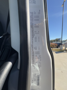 Truck door sticker label showing vehicle specifications for a 2026 Mack PR64T, including VIN 1M1PR4GY6TM100656 and stock number 71171 visible on the door jamb.