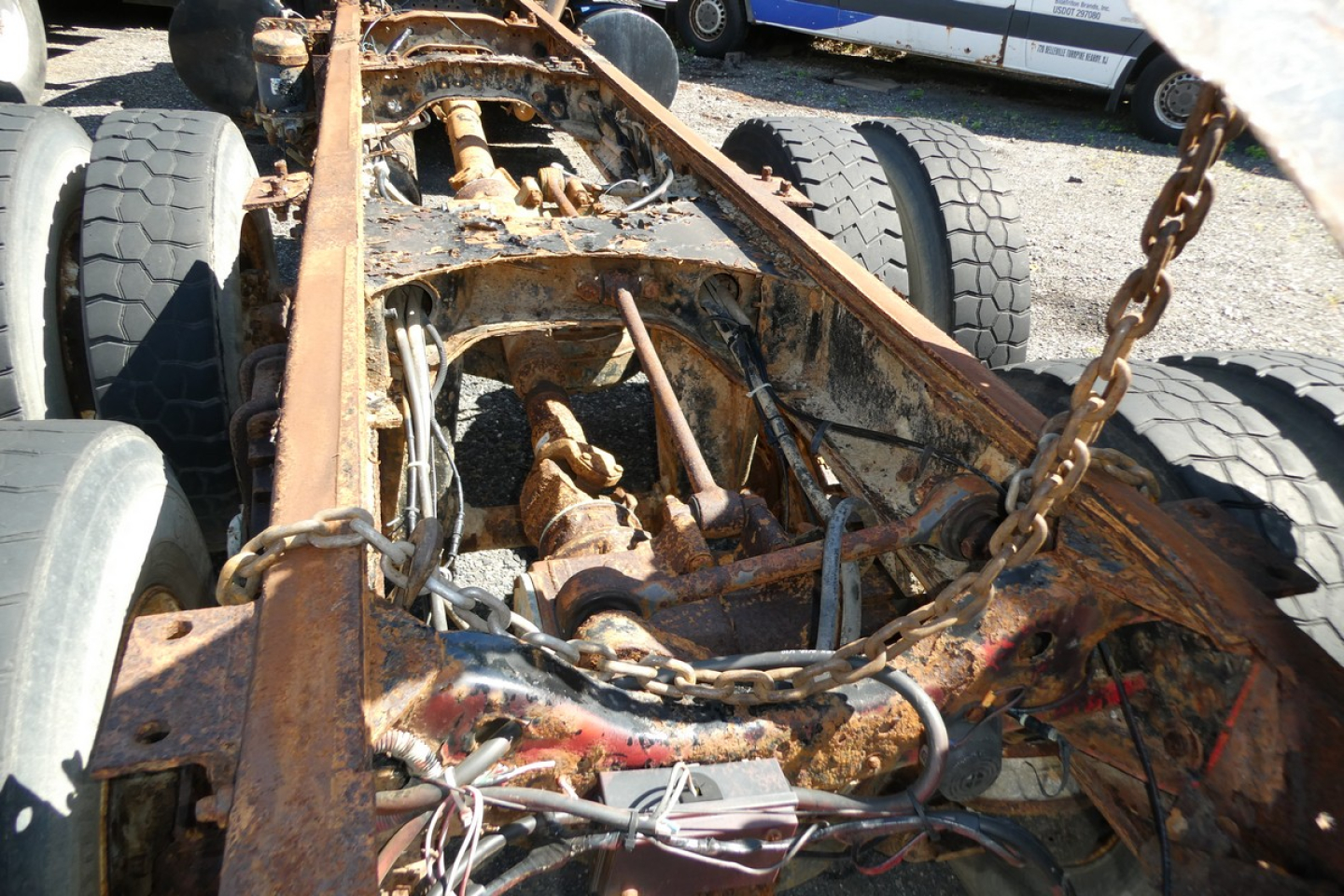 Equipment image showing a rusty Mack RD688S cab chassis frame with exposed drivetrain and suspension components.