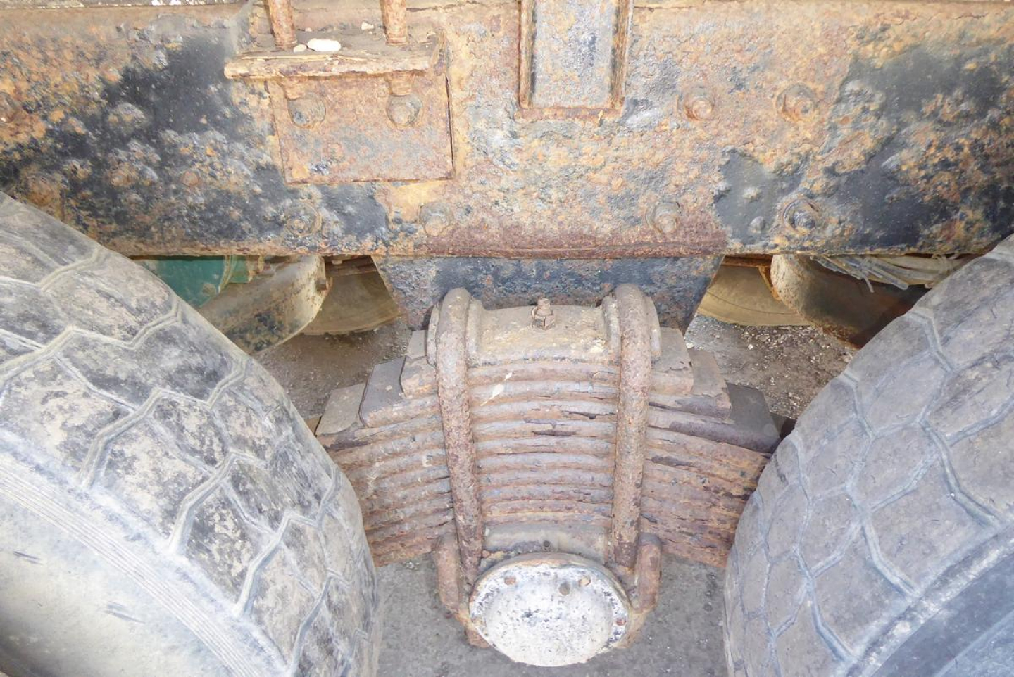 Mack RD688S truck rear undercarriage showing differential and dual tires with rusted chassis