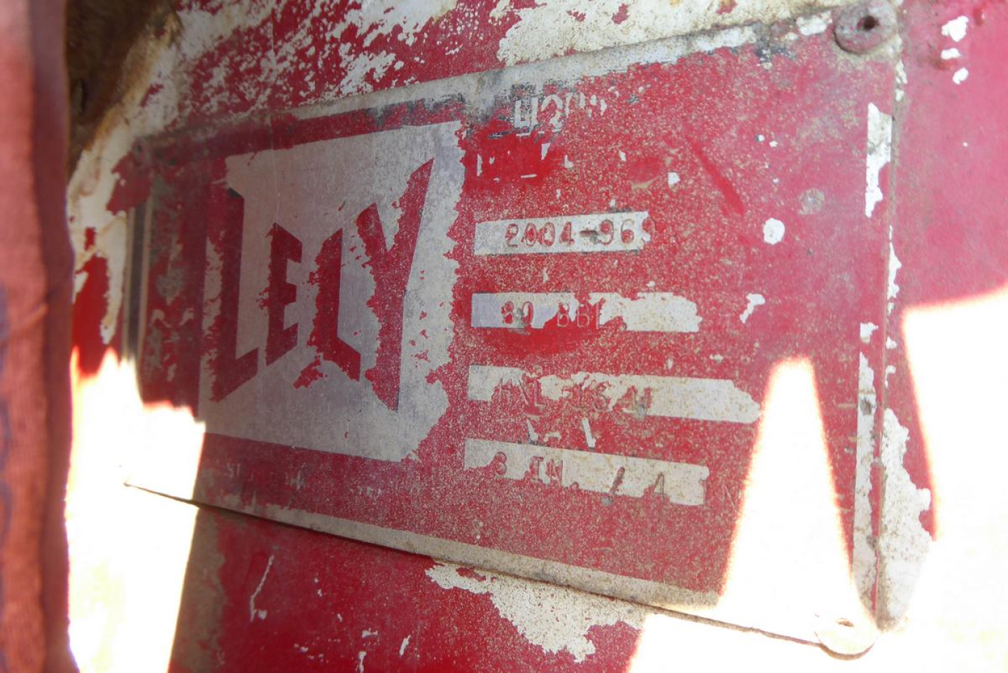 Mack RD688S cab and chassis identification plate with LeLy branding and worn red paint