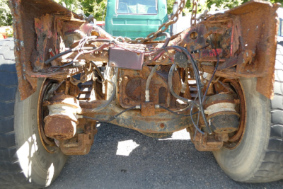 Mack RD688S rear drivetrain view showing rust on suspension axles and driveline components