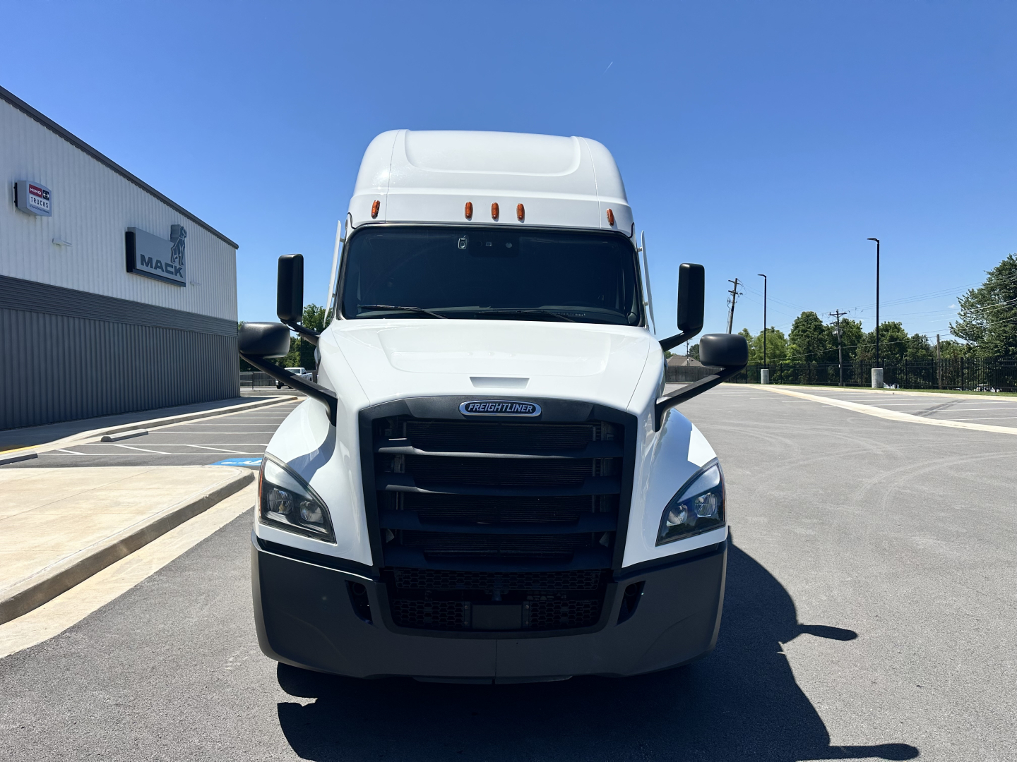 Front view of a 2023 Freightliner Cascadia 126 sleeper cab truck. The grille shows Freightliner logo; side mirrors; hood; windshield. No visible text on badges legible.
