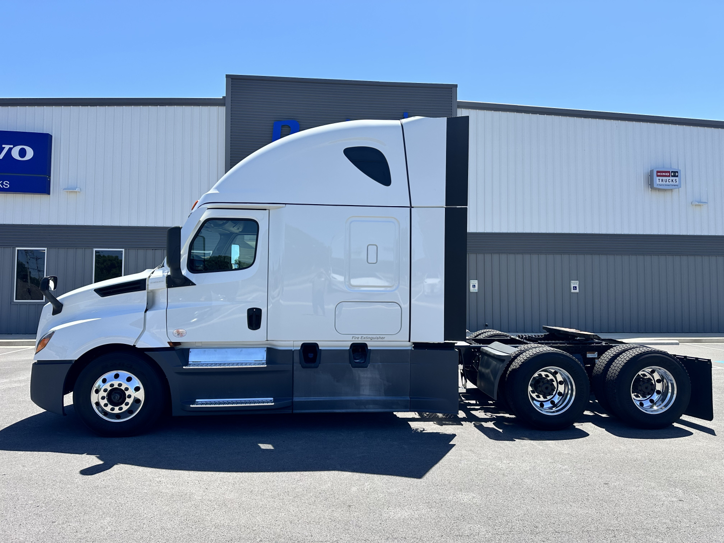 Freightliner Cascadia 126 truck in side profile showing sleeper cab, twin rear axles, fuel tanks, and wheel rims.