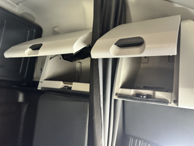 Cab interior showing sun visor panels and overhead compartments in a Freightliner Cascadia 126; no legible text or labels visible.