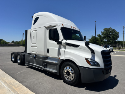Freightliner Cascadia 126 tractor cab in white, side view, with sleeper, 6-wheel rear, no trailer, chrome hubcaps and black lower body trim.