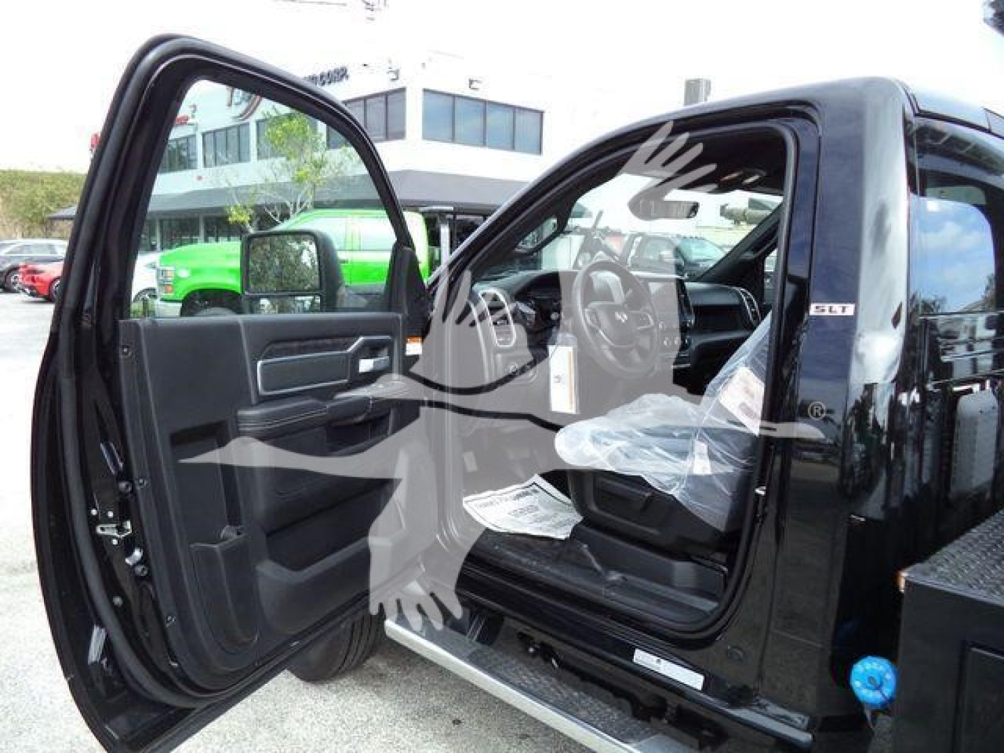 Ram 4500 pickup truck with front door open, SLT badge visible, showing interior and black exterior