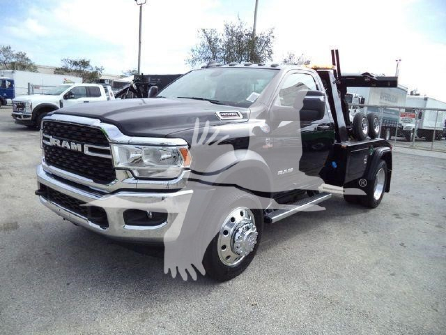 Ram 4500 Tow Truck front-left view showing chrome grille, RAM badge, dual rear wheels with winch setup and flatbed on bed.