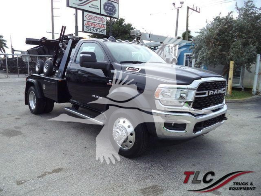 Ram 4500 heavy-duty truck with a black body and winch equipment, front grille with RAM emblem, large dual rear wheels, auxiliary lights, and service decals.