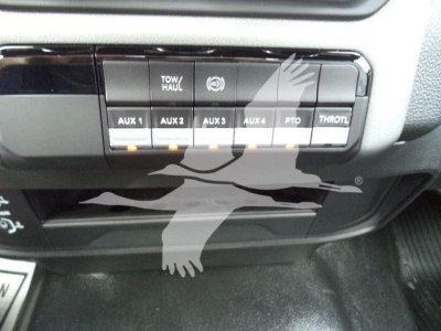 Ram 4500 dash panel showing AUX switches labeled AUX 1 AUX 2 AUX 3 AUX 4, TOW/HAUL, PTO, THROTTLE, with additional small icons.