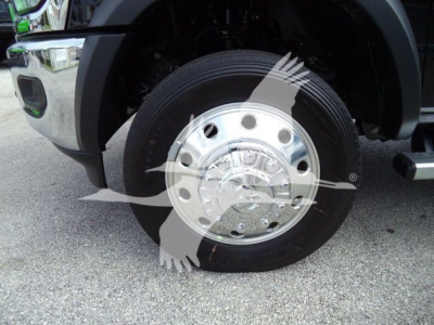 Ram 4500 front wheel area showing polished dual-tone hubcap and tire, part of the left front fender and wheel well visible.