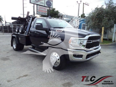 Ram 4500 heavy-duty truck with a black body and winch equipment, front grille with RAM emblem, large dual rear wheels, auxiliary lights, and service decals.