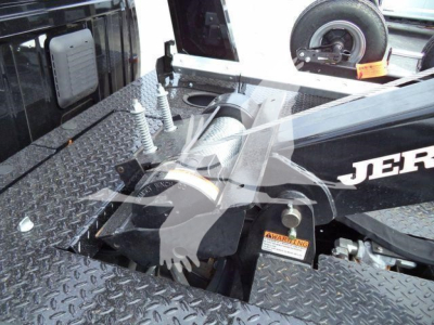 Ram 4500 SLT winch truck bed showing winch area and diamond plate platform with tire on the side and warning label visible.