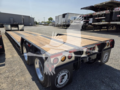 Flatbed trailer showing tandem axles and wooden deck