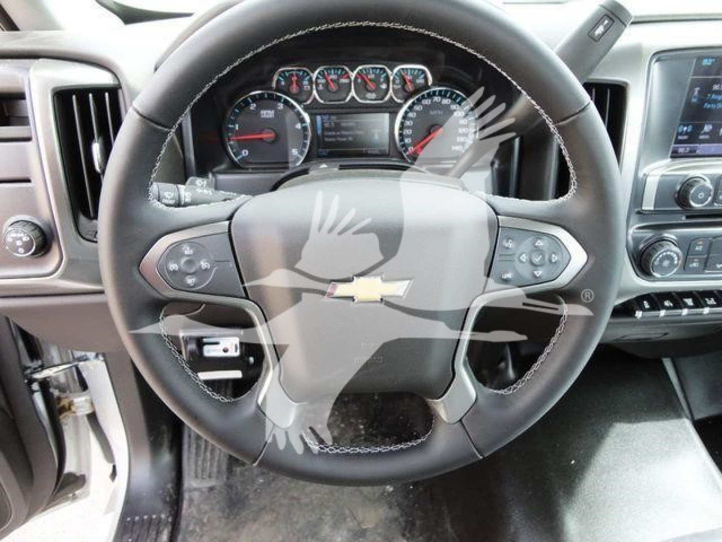 Chevrolet Silverado 6500HD interior showing steering wheel with Chevrolet logo and dashboard gauges.