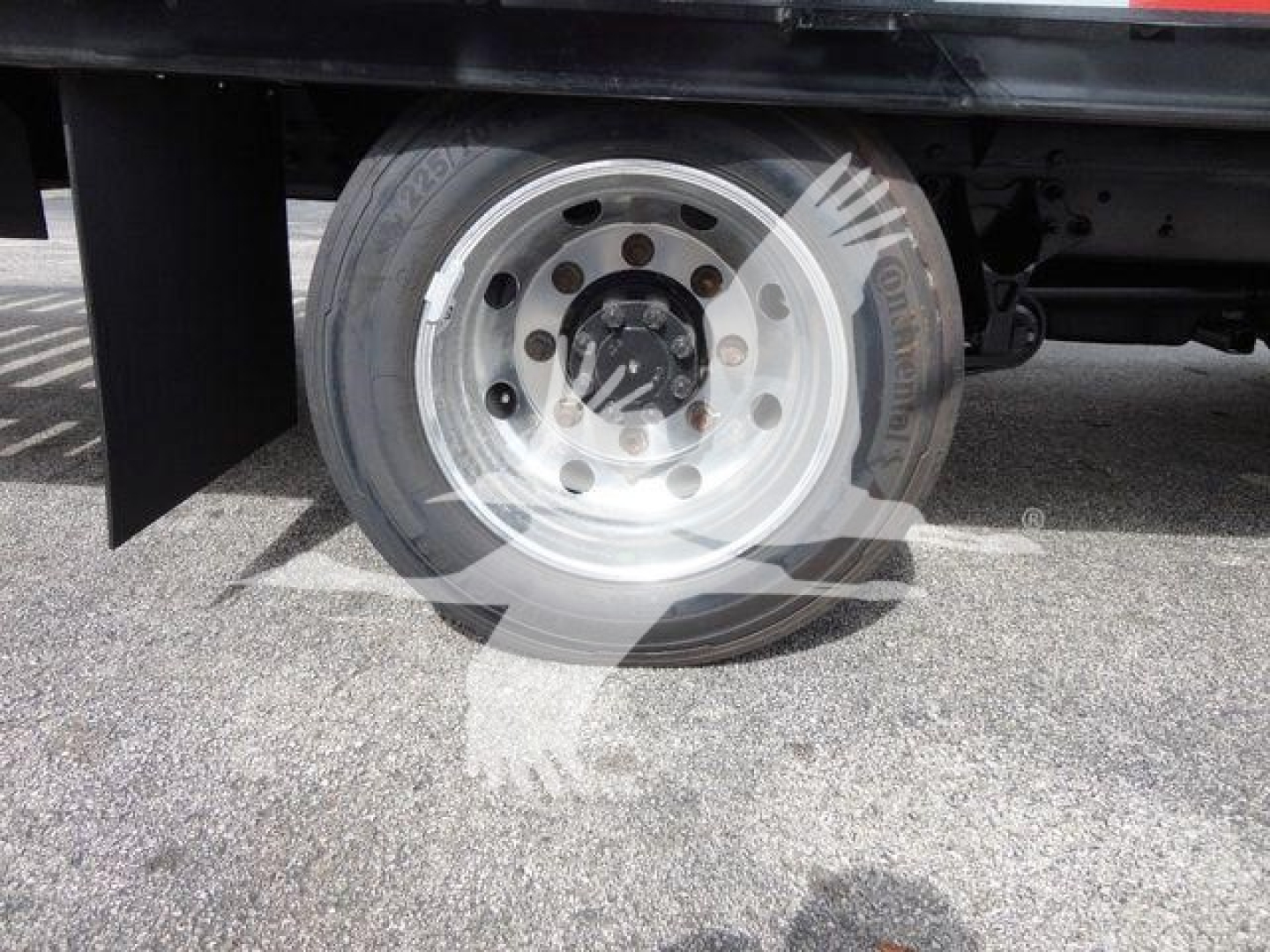 Chevrolet Silverado 6500HD wheel and front dual rear tires showing wheel hub and flatbed base.