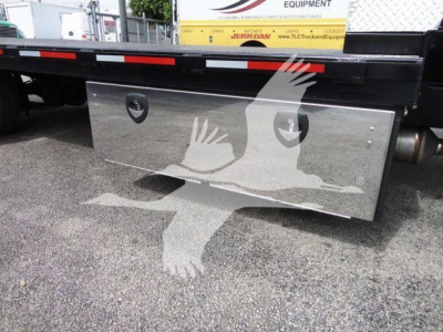 Chevrolet Silverado 6500HD flatbed truck in-service side view showing polished stainless toolbox with two round recessed handles.