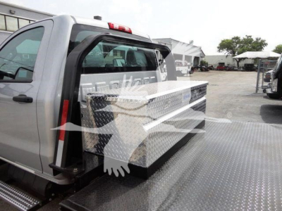 Chevrolet Silverado 6500HD flatbed truck with diamond-plate toolbox mounted behind cab