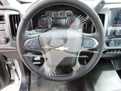 Chevrolet Silverado 6500HD interior showing steering wheel with Chevrolet logo and dashboard gauges.