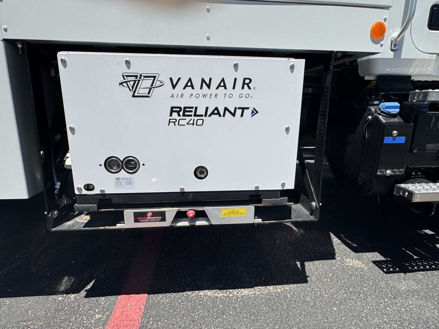 Front undercarriage of 2025 Mack MD7 showing Vanair Reliant RC40 auxiliary power unit with logos VANAIR and RELIANT RC40.