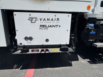 Front undercarriage of 2025 Mack MD7 showing Vanair Reliant RC40 auxiliary power unit with logos VANAIR and RELIANT RC40.