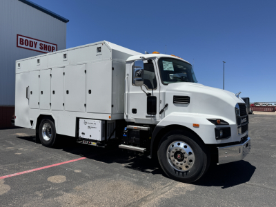 Mack MD7 utility service truck in white, side view showing multiple storage compartments and cargo box on a heavy-duty chassis.