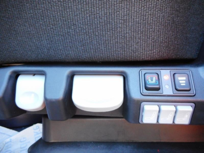 Seat area of a new Western Star 47X dump truck cockpit showing control panel and seat adjustment switches.