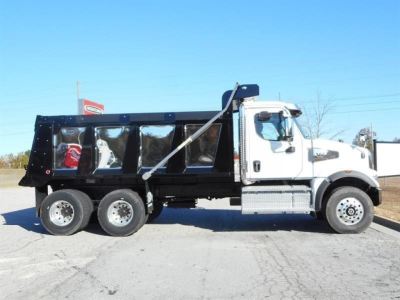 Western Star 47X dump truck side view showing white cab and black dump bed with straps and dual rear axles.